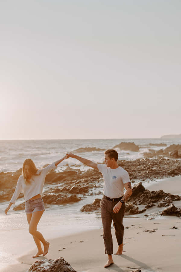 Download Couple At Beach Blue Skies Wallpaper | Wallpapers.com