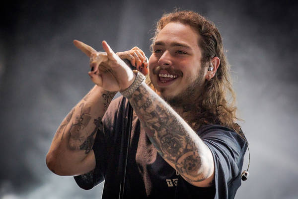 Download Post Malone Showing Off His Signature Style | Wallpapers.com