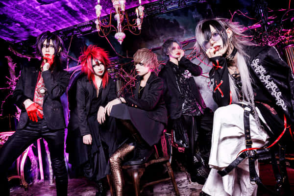 Download Members of a Visual Kei band posing amidst dramatic lighting ...