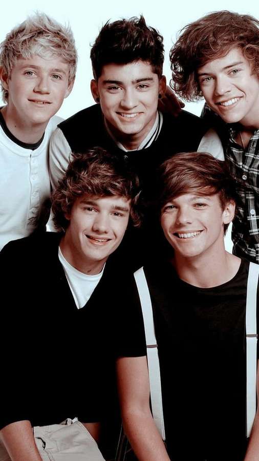 Five young men smiling in a group photo wearing casual clothes. — 1 Direction iPhone Wallpaper