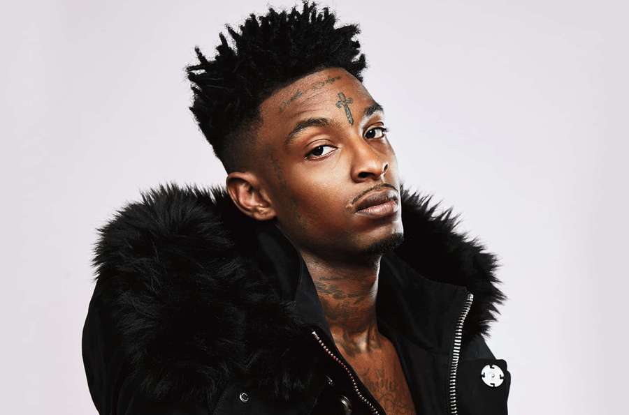 Portrait of a man with tattoos wearing a black fur-lined jacket. — 21 Savage Background