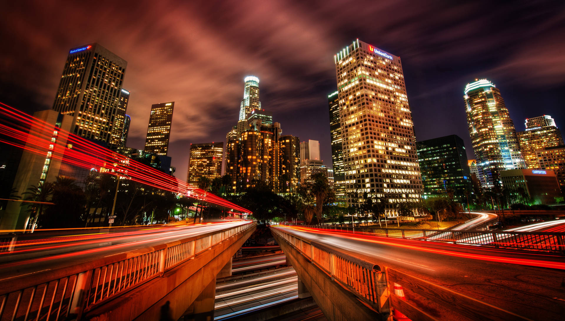 A 4K ultra hd wallpaper of a futuristic cityscape at night, with neon  lights illuminating the towering skyscrapers and hovercars zooming through  the air, while a full moon casts a soft blue