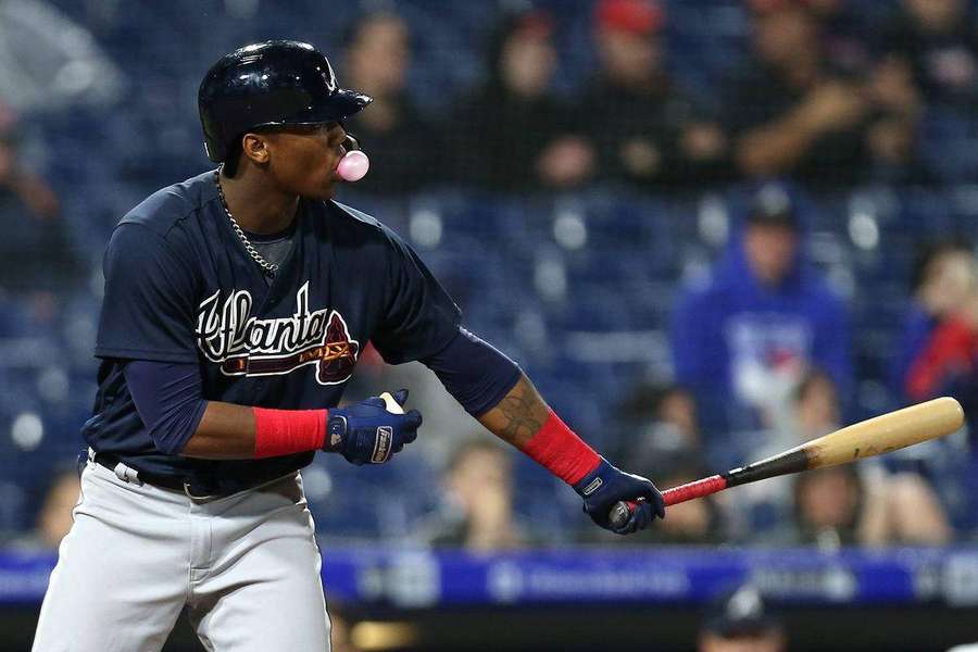 Baseball player blowing pink bubblegum bubble at night in stadium. — Acuna Wallpaper