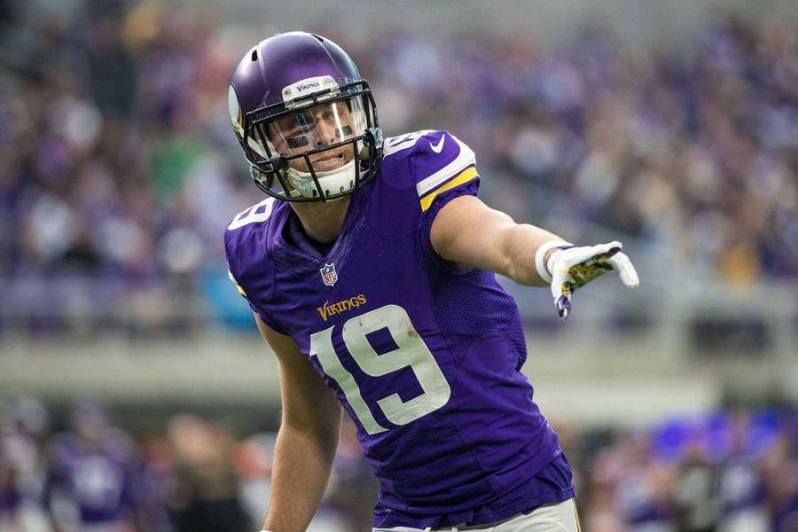 Football player in purple Vikings jersey number 19 celebrating on field. — Adam Thielen Background