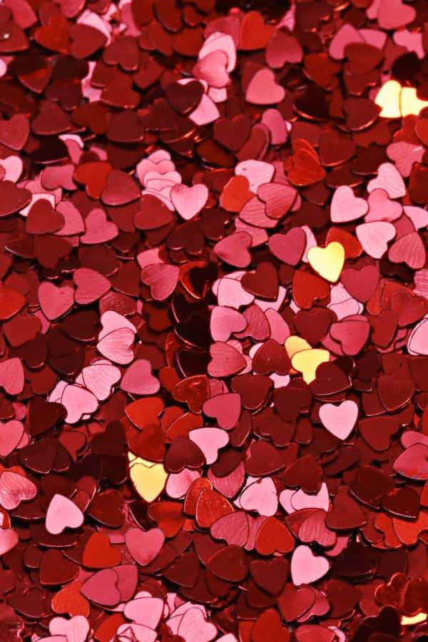 Shiny red pink and gold heart-shaped confetti scattered densely. — Aesthetic Red Background