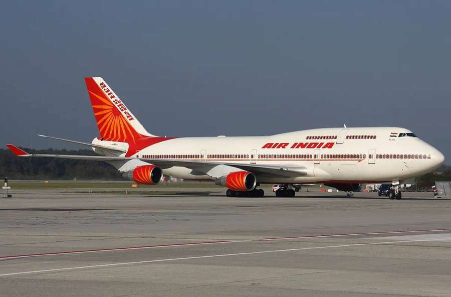 Air India Boeing 747 on airport tarmac with red sunburst tail — Air India Wallpaper