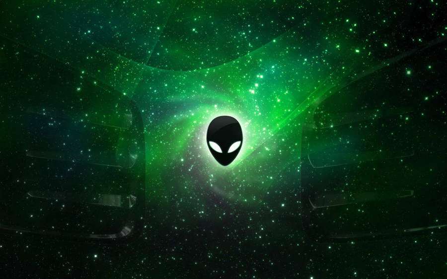 Alien logo glowing in green cosmic vortex with stars — Alienware Logo Wallpaper
