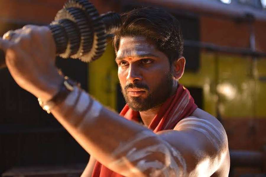 A man with white markings on his arms holds a spiked mace during sunset. — Allu Arjun Wallpaper