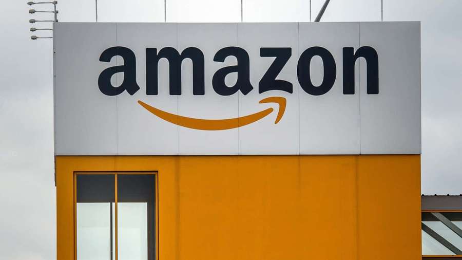 Amazon corporate building with logo under cloudy sky — Amazon Background