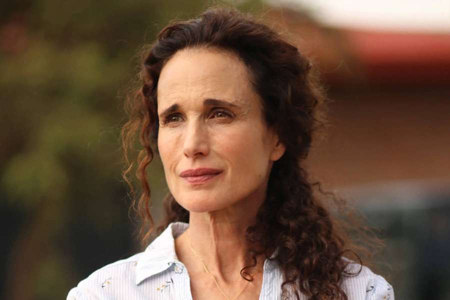 Woman with curly hair wearing a patterned shirt and necklace outdoors. — Andie macdowell Wallpaper