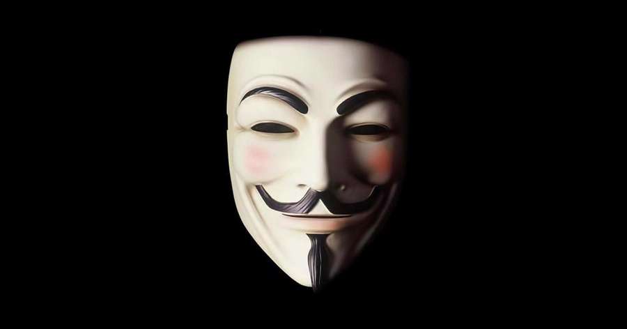 White Guy Fawkes mask with rosy cheeks and wide grin against black background. — Anonymous Picture