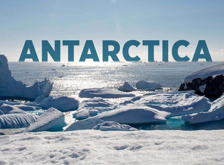 Antarctica icebergs floating in ocean under clear sky with text overlay — Antarctica Background