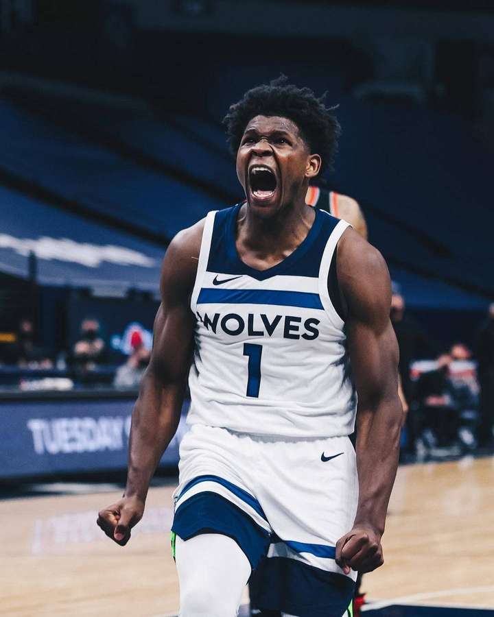 Basketball player in Wolves jersey celebrating victory on court. — Anthony Edwards Background