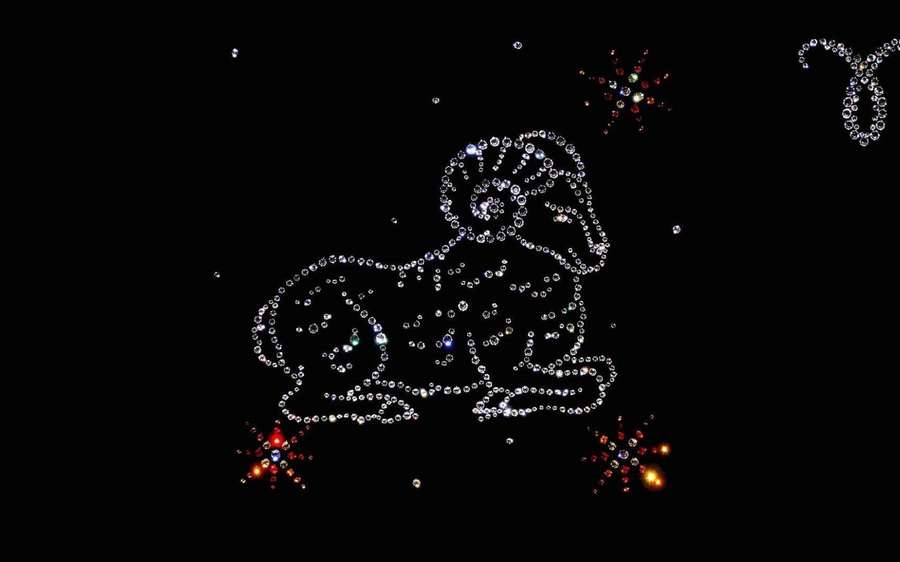 A rhinestone constellation of a ram with colorful starbursts on a black background. — Aries Wallpaper