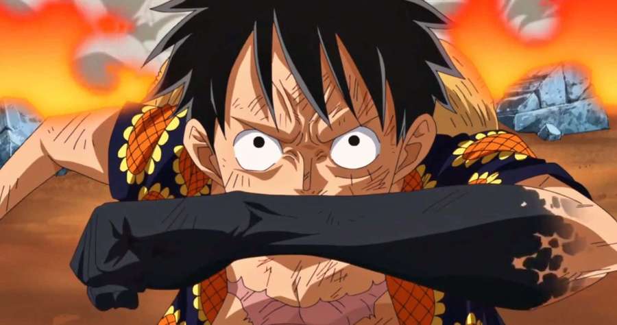 Anime pirate with spiky hair gripping his arm amid flames and rocks. — Armament Haki Wallpaper