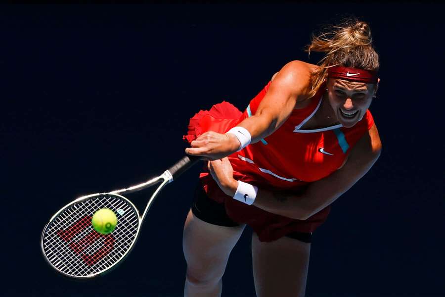 Tennis player in red outfit hitting a ball with intense focus. — Aryna Sabalenka Background