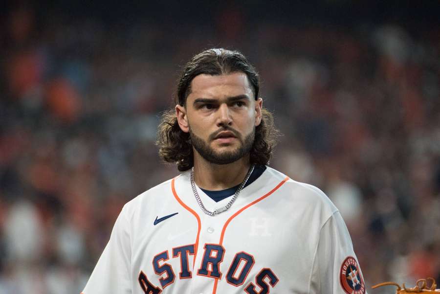 Baseball player in Astros uniform looking serious at night game. — Astros Wallpaper