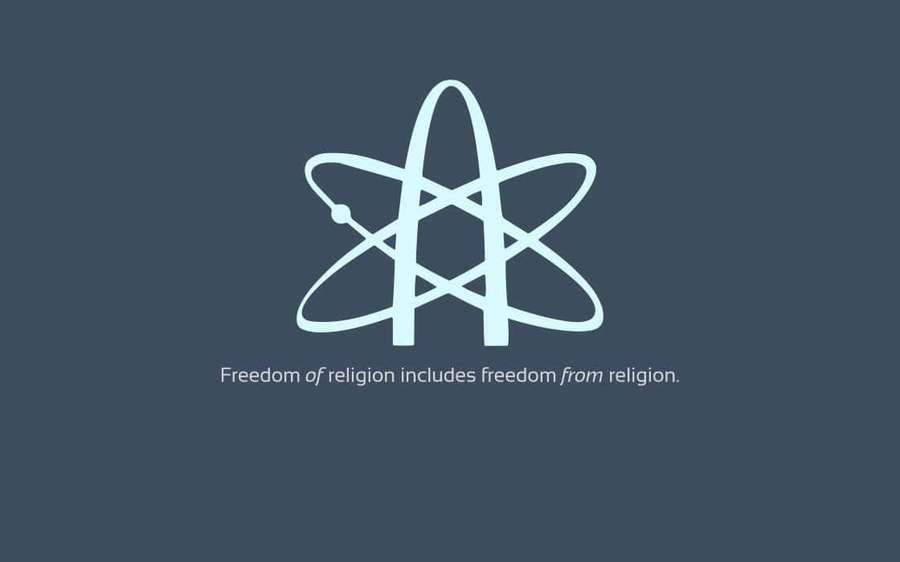 A light blue atom symbol with text about freedom of religion on a teal background. — Atheist Wallpaper