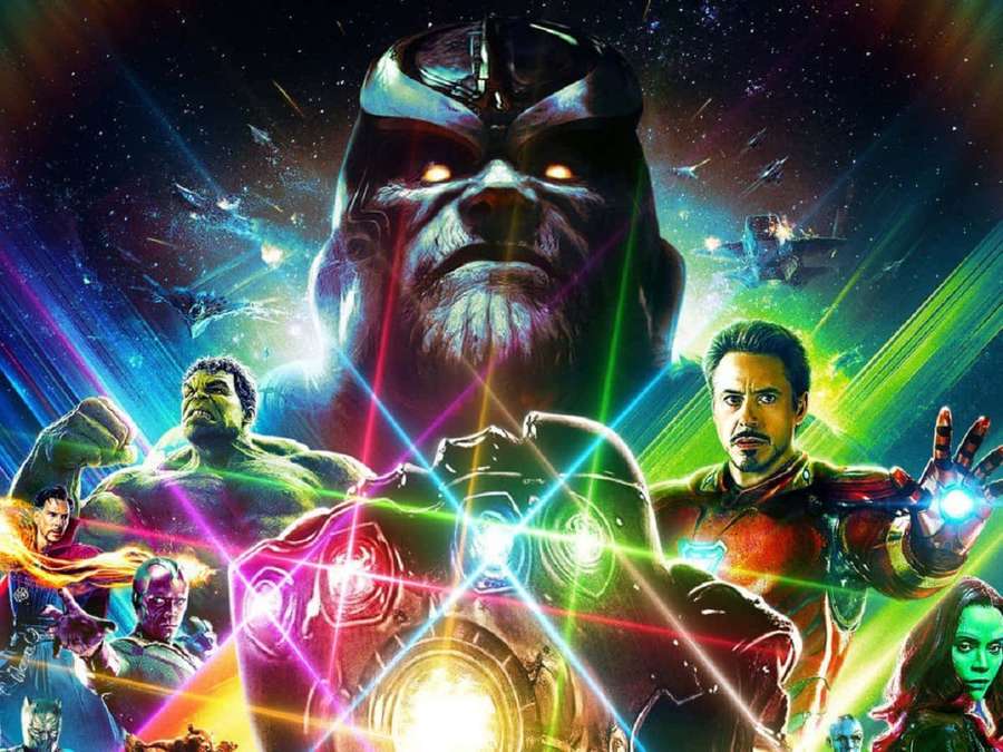 Thanos towers over Avengers heroes in a cosmic battle with laser beams and starry space. — Avengers Infinity War Background