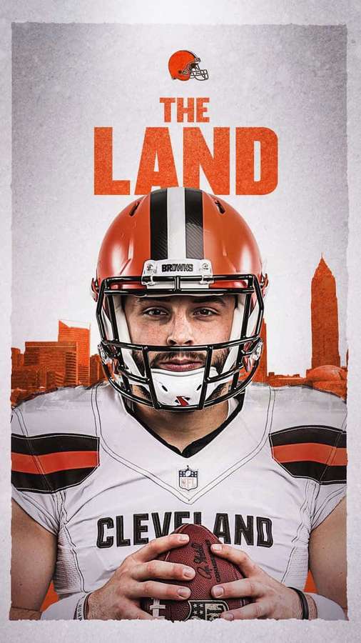Cleveland Browns Footballspieler hält einen Football mit Stadtsilhouette und dem Text 'The Land'. — Baker Mayfield Hintergrundbild