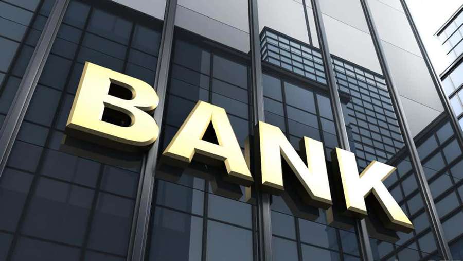 Golden bank sign on a modern glass office building facade. — Bank Background