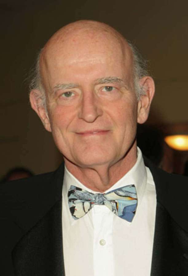 An older man in a tuxedo with a patterned bow tie smiles at the camera. — Barry Tv Show Wallpaper
