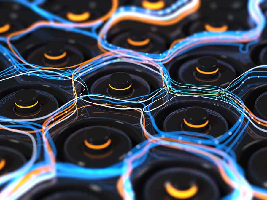 Glowing blue and orange fiber optic cables connecting black circular ports in a grid. — Battery Wallpaper