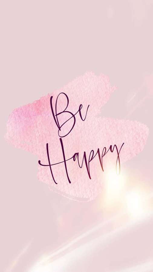 Motivational text 'Be Happy' in elegant script over soft pink watercolor background with glowing light rays. — Be Happy Wallpaper