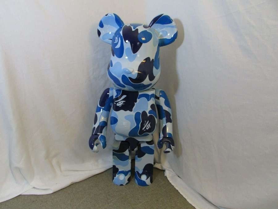 Glossy blue and white camo bear figurine standing in studio setting. — Bearbrick Wallpaper