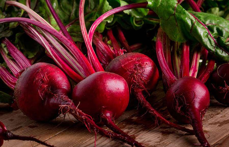 Fresh beetroots with green leaves on wooden surface — Beetroot Picture