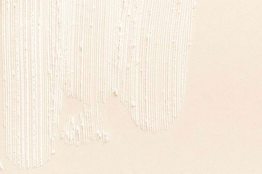 Creamy white paint drips on beige wall with textured brush strokes. — Beige Desktop Background