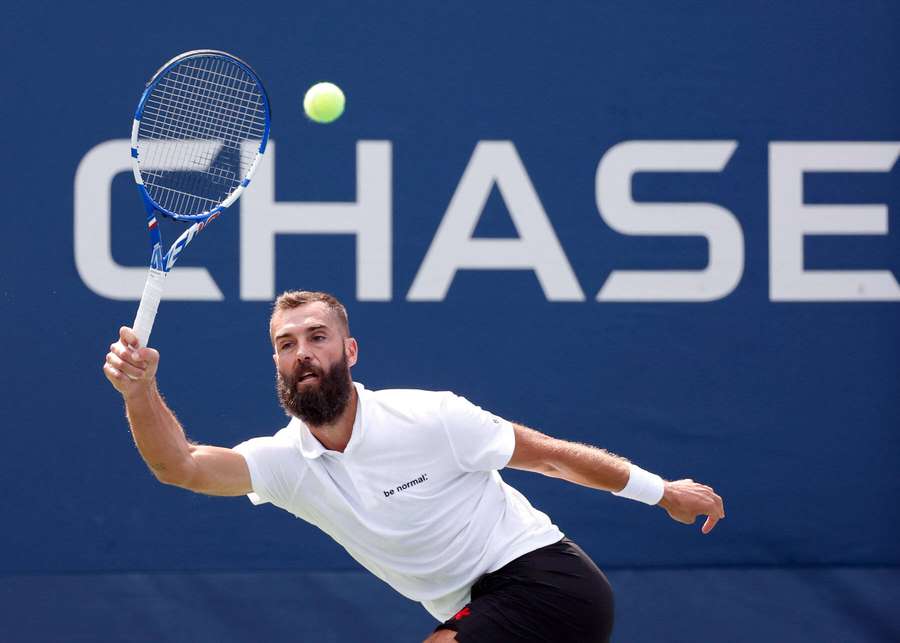 Tennis player with beard swinging racket at ball on court. — Benoit Paire Wallpaper