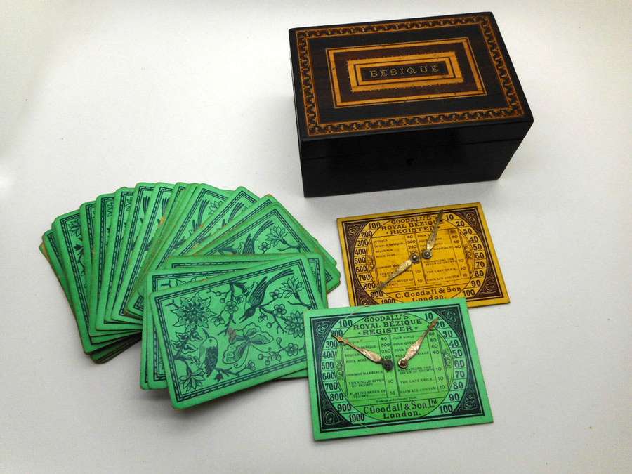 Vintage Besique playing cards and register cards with ornate box on white background — Bezique Wallpaper