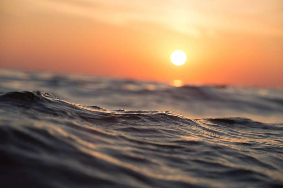 Sunset over ocean waves with warm orange glow — Big 3d Desktop Wallpaper