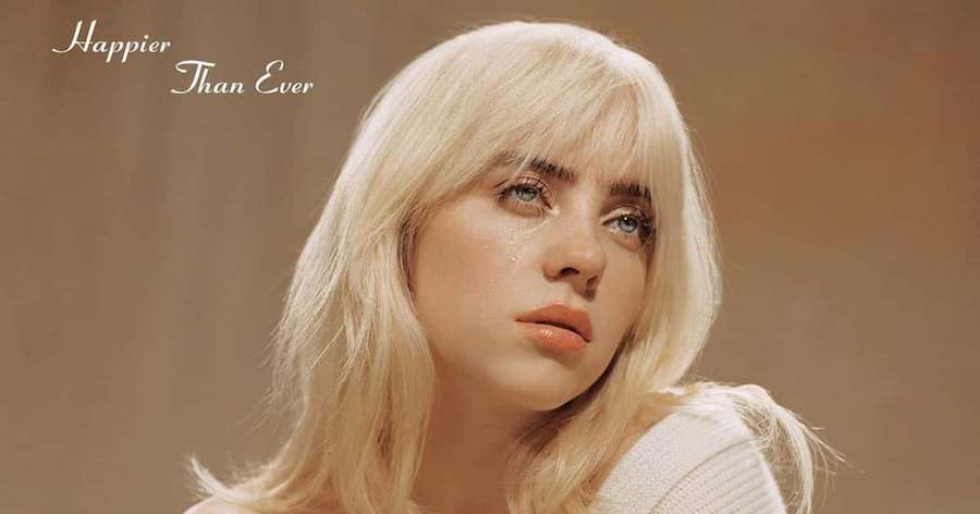 Billie Eilish with tear on cheek in beige background with album text. — Billie Eilish Picture