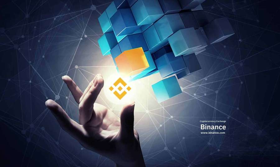 Hand, die nach schwebenden blauen Würfeln greift, mit Binance-Logo, das in der Mitte leuchtet. — Binance Hintergrundbild