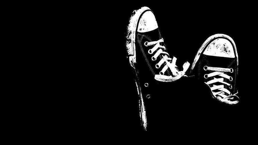 Two worn sneakers in white against black background with textured style. — Black Cool Wallpaper