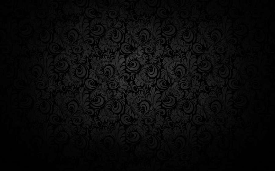 Black damask wallpaper with intricate swirling floral designs.