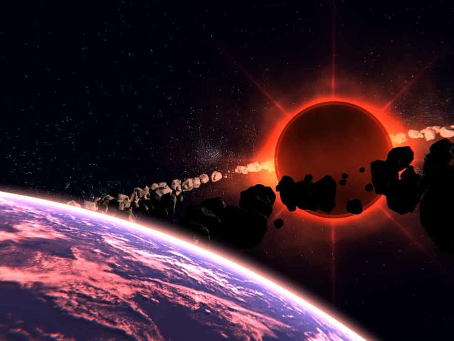 A red sun eclipsed by a planet with asteroids drifting past a colorful planet below. — Black Hole Sun Wallpaper