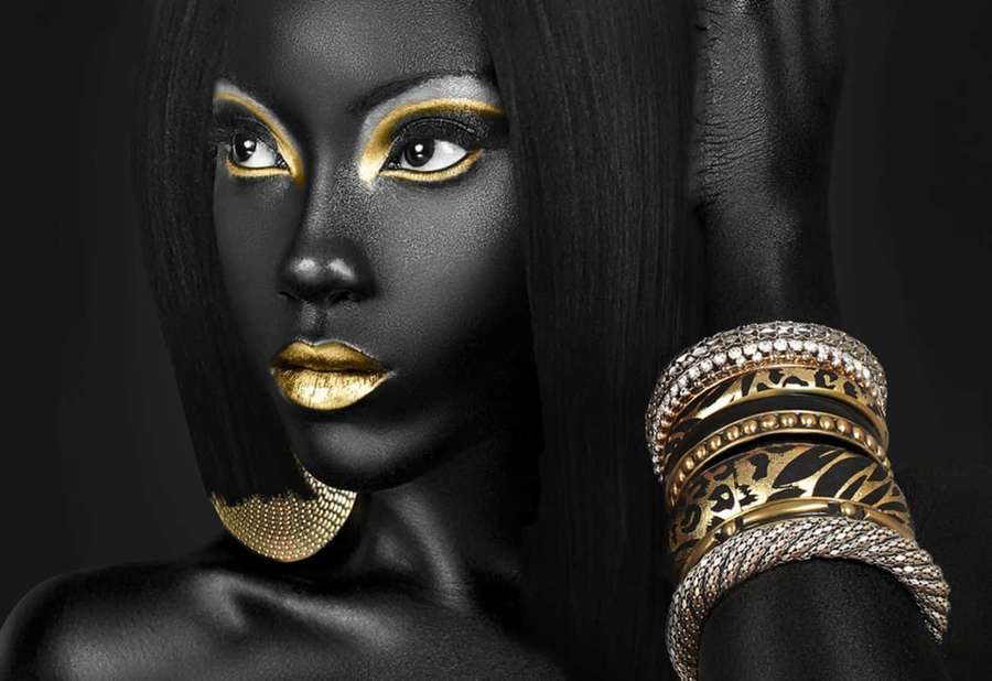 A woman with black skin and gold makeup wearing ornate gold jewelry. — Black Is Beautiful Wallpaper