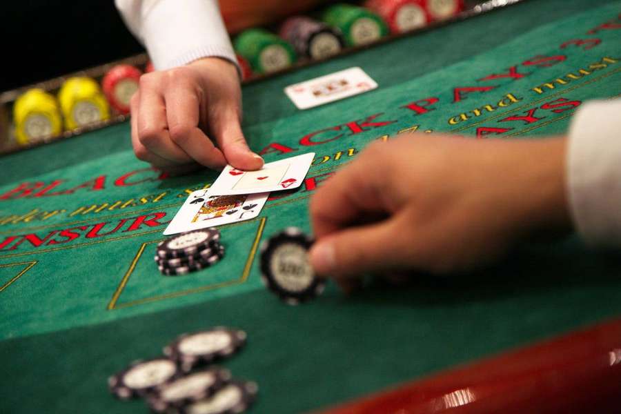 Close-up of hands playing blackjack with cards and chips on a casino table. — Blackjack Wallpaper