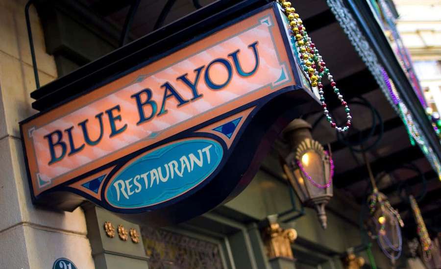 Blue Bayou Restaurant sign with beads and lanterns hanging at night. — Blue Bayou Wallpaper