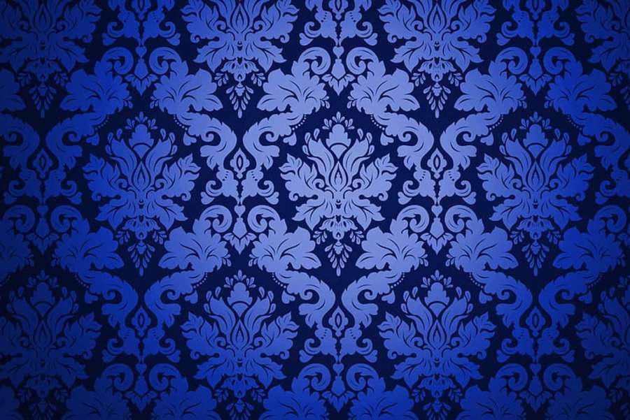 Blue damask wallpaper with intricate floral and scrollwork design.