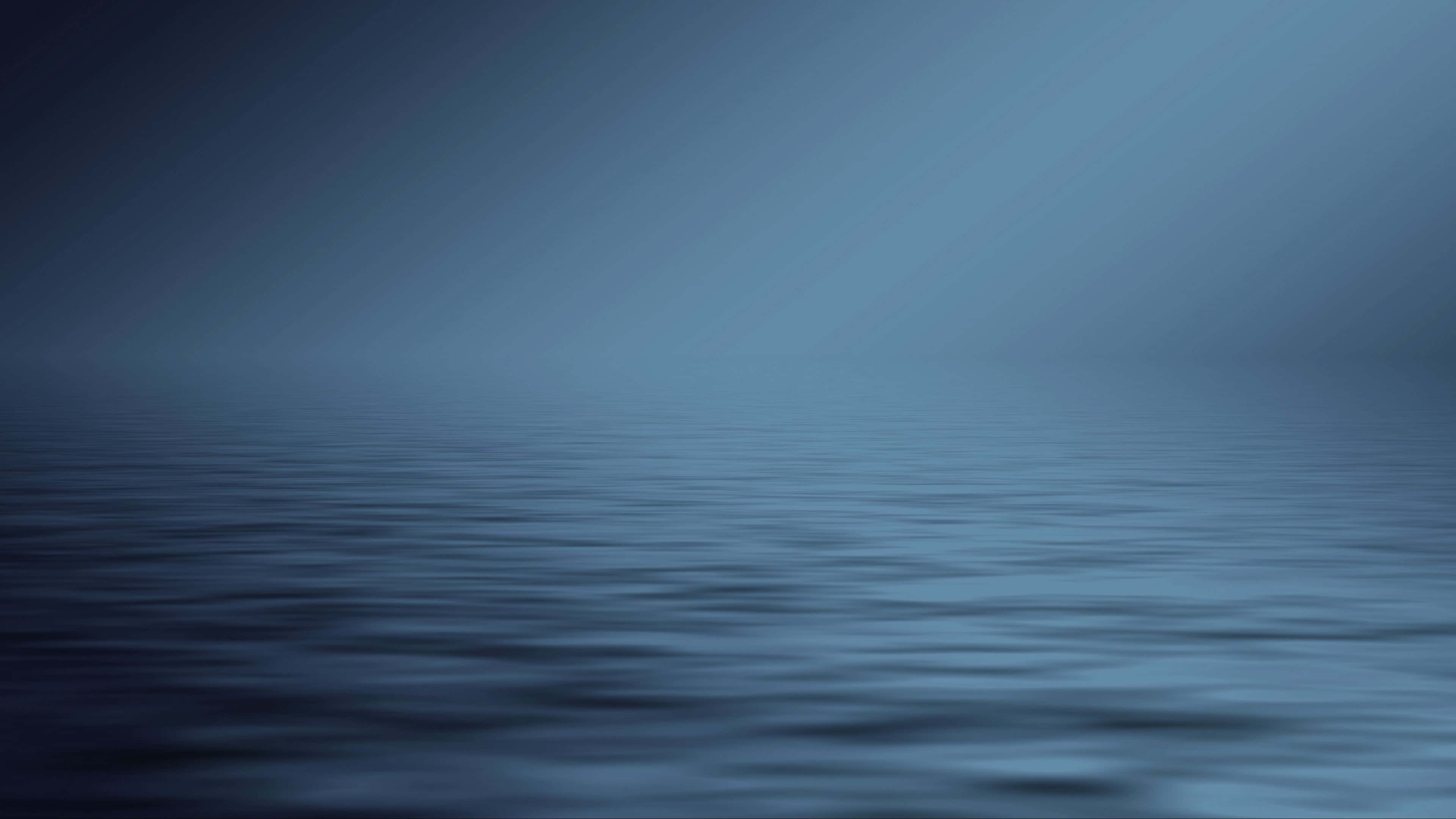 Calm blue water with mist and soft light creating a peaceful atmosphere. — Blue Gray Background