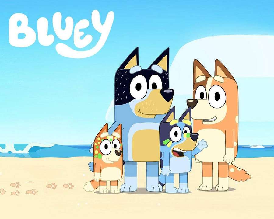 Bluey and family cartoon characters on a sunny beach with ocean waves. — Bluey Background