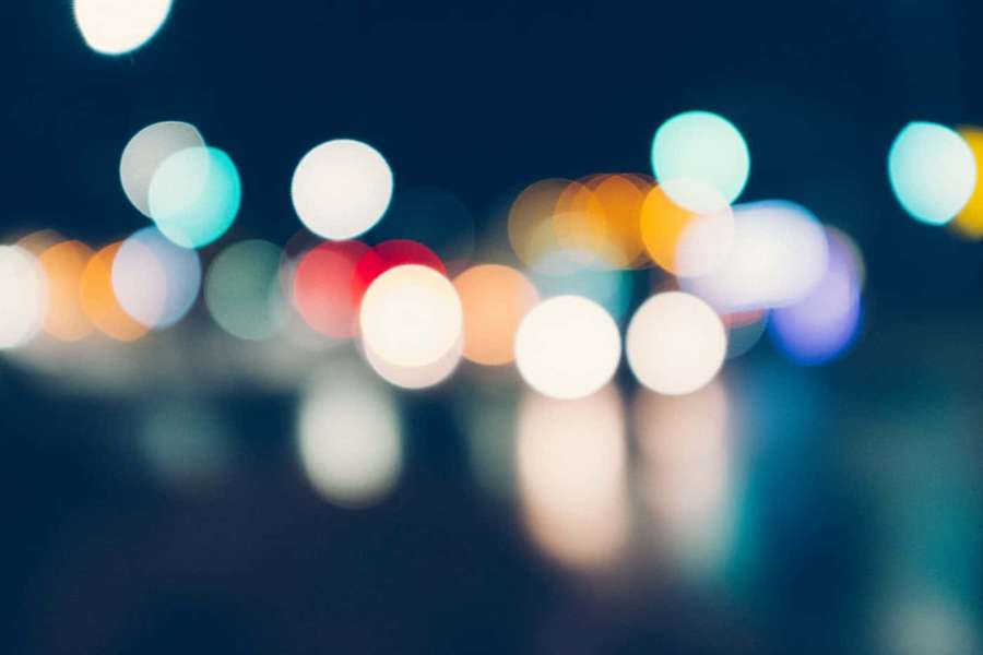 Soft glowing bokeh lights in a nighttime city scene. — Blur Zoom Background