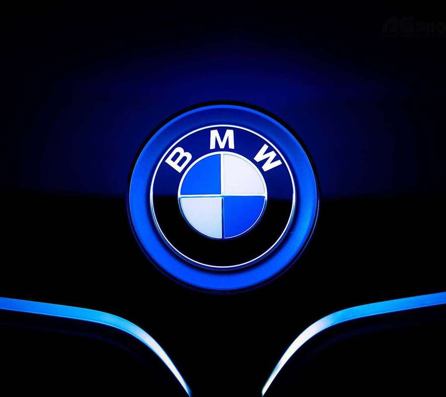 Glowing BMW logo with blue lighting on a dark car surface. — Bmw Logo Wallpaper
