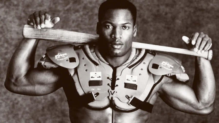 Athletic football player in chest protector holding bat over shoulders. — Bo Jackson Picture