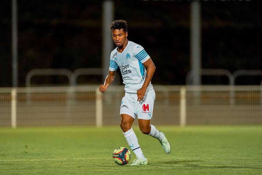 Jugador de fútbol regateando balón en campo de césped bajo las luces del estadio por la noche. — Boubacar Kamara Fondos de pantalla