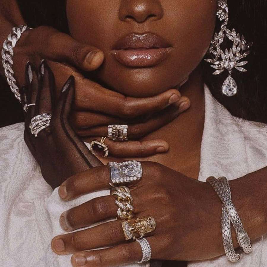 A woman wearing opulent diamond jewelry including rings earrings and bracelets. — Boujee Aesthetic Background